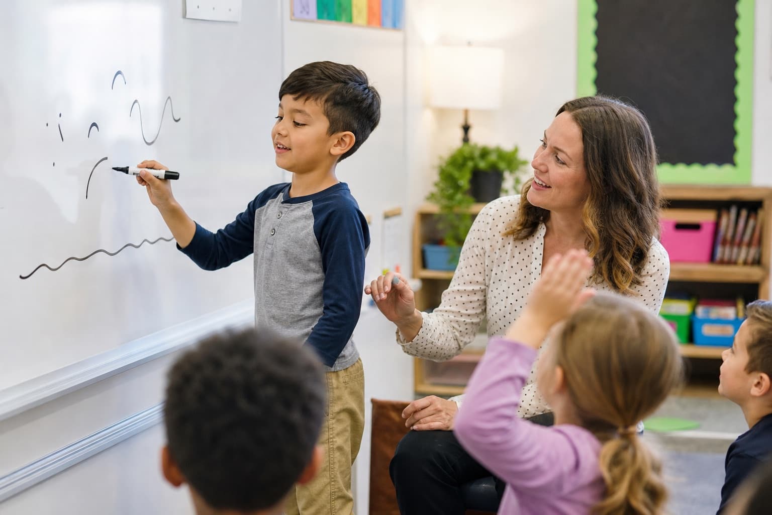 Student blending sounds on a classroom whiteboard during an explicit phonics lesson.