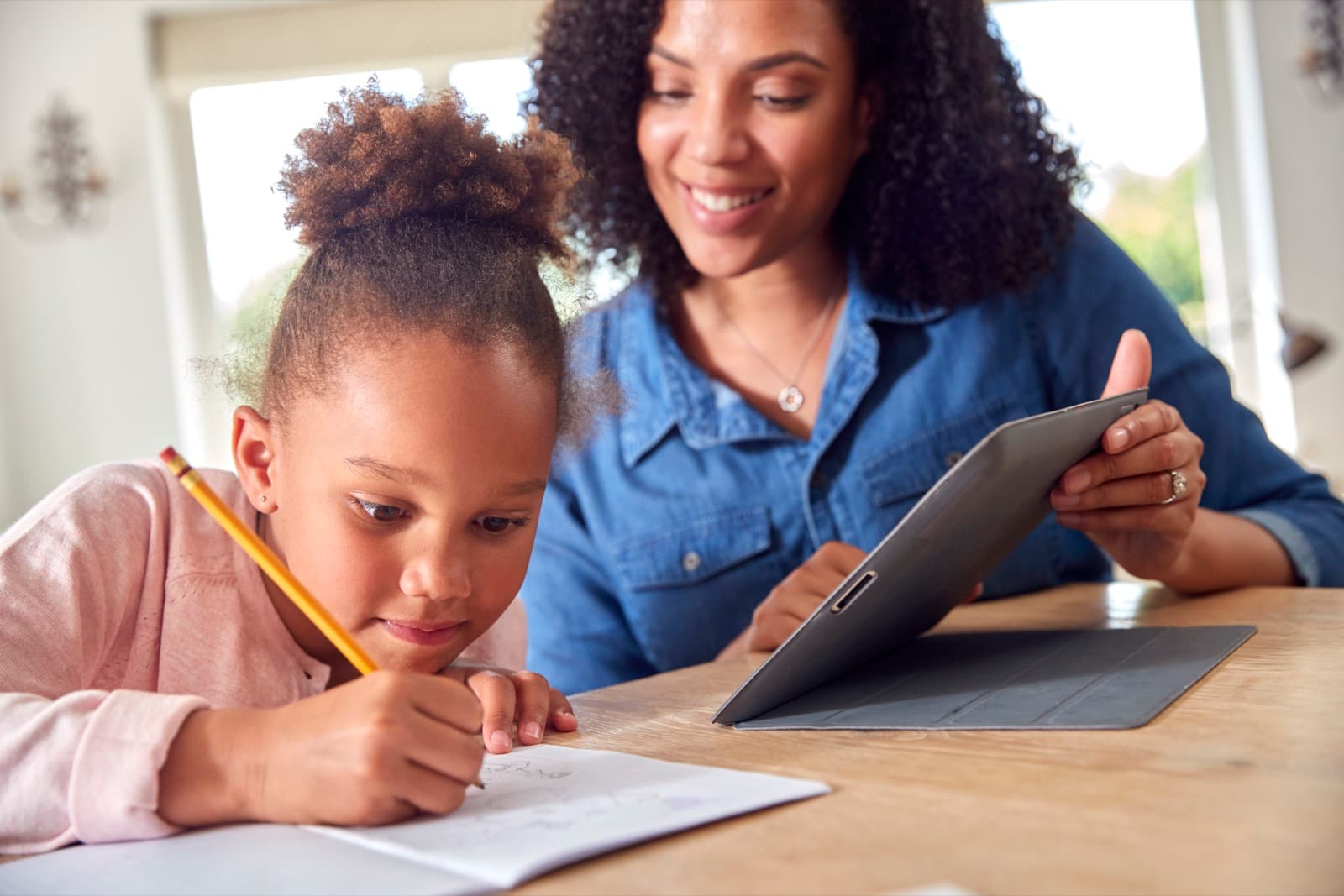 Adult and child working on reading activities together